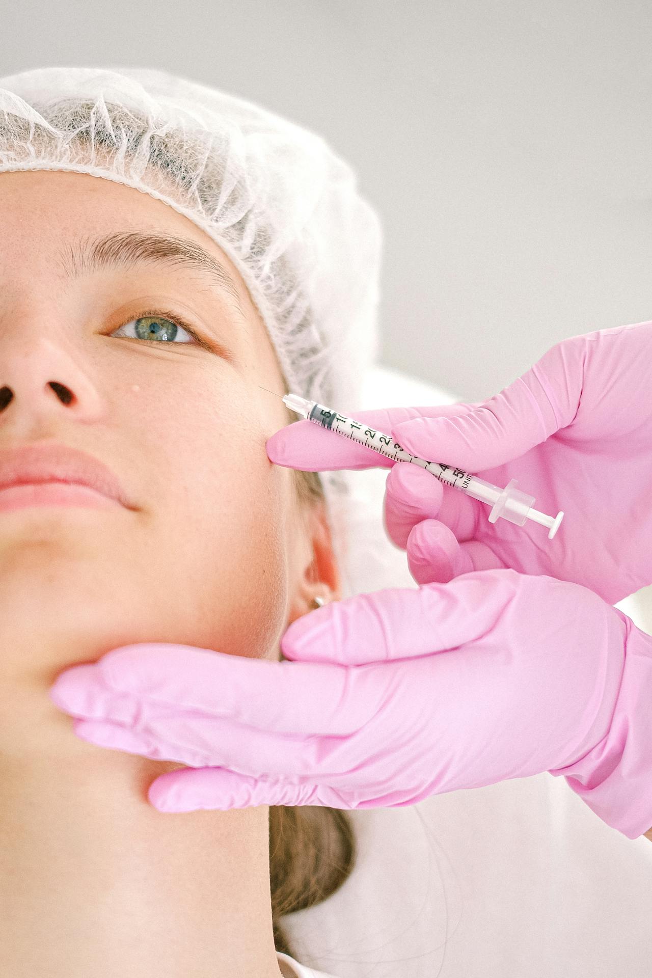 Woman receiving filler treatment for facial contouring and hydration